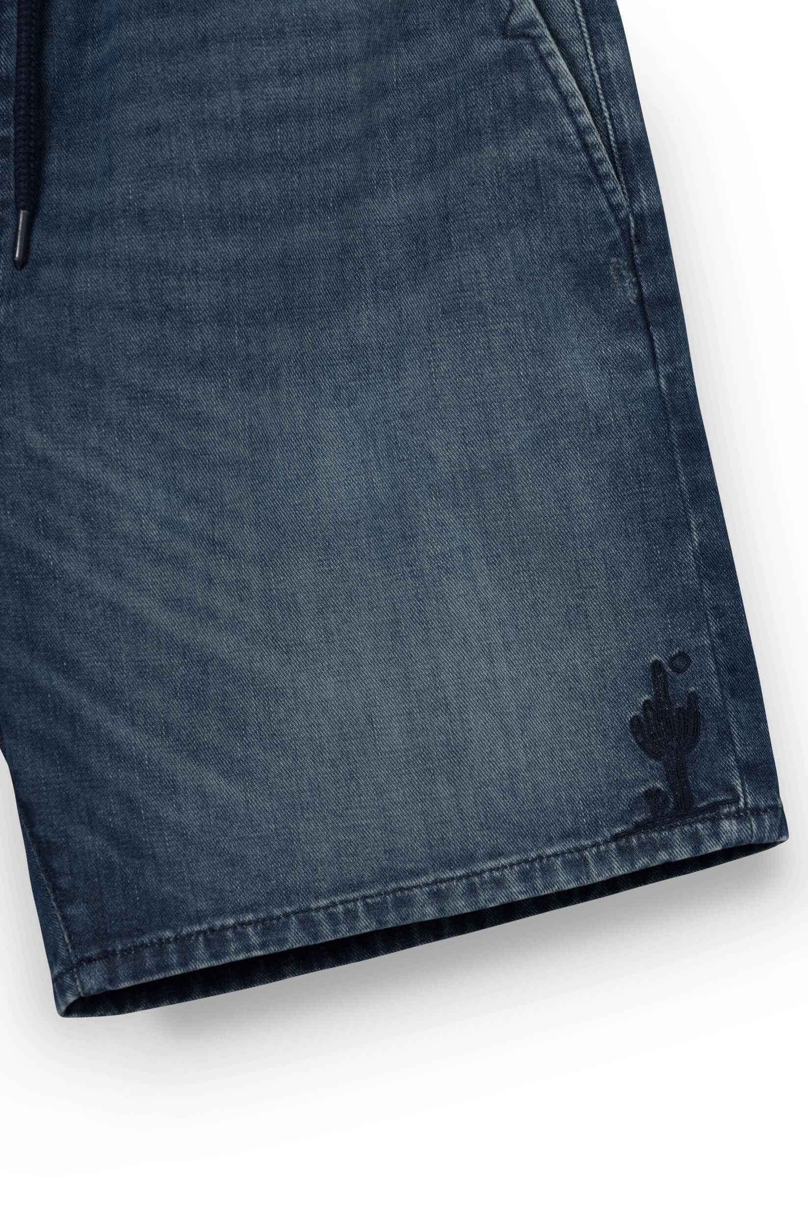 Close-up on the cactus pattern of the blue shorts