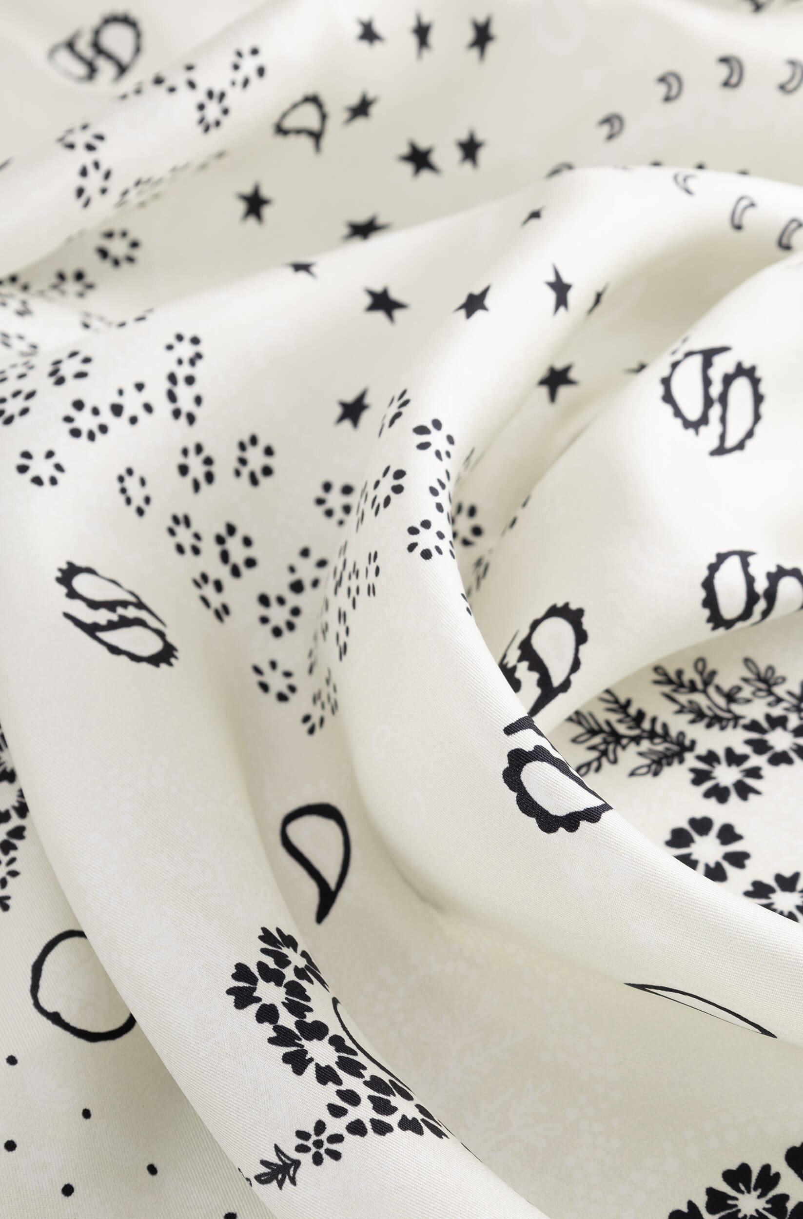 Detail with texture of the white silk scarf with bandana pattern