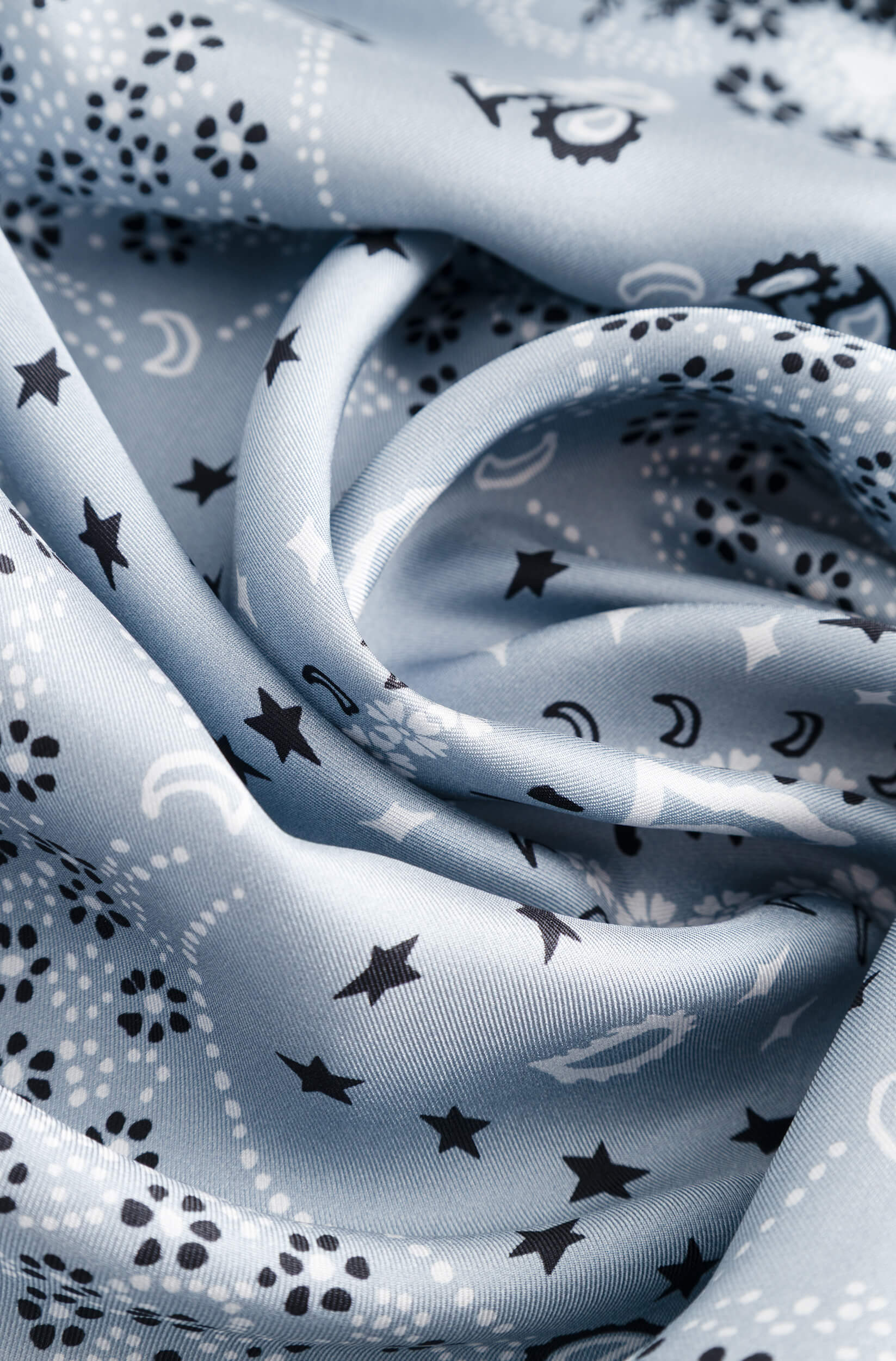 Detail with texture of the glacier blue silk scarf with bandana pattern
