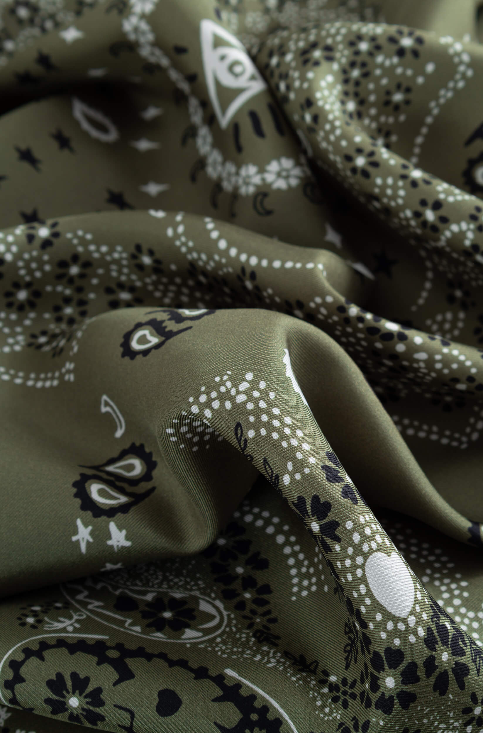 Detail with texture of the khaki silk scarf with bandana pattern