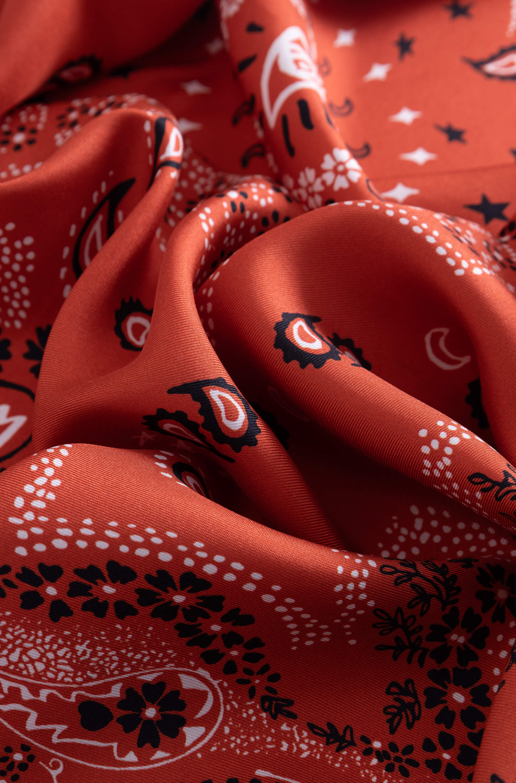 Detail with texture of the silk scarf with bandana pattern