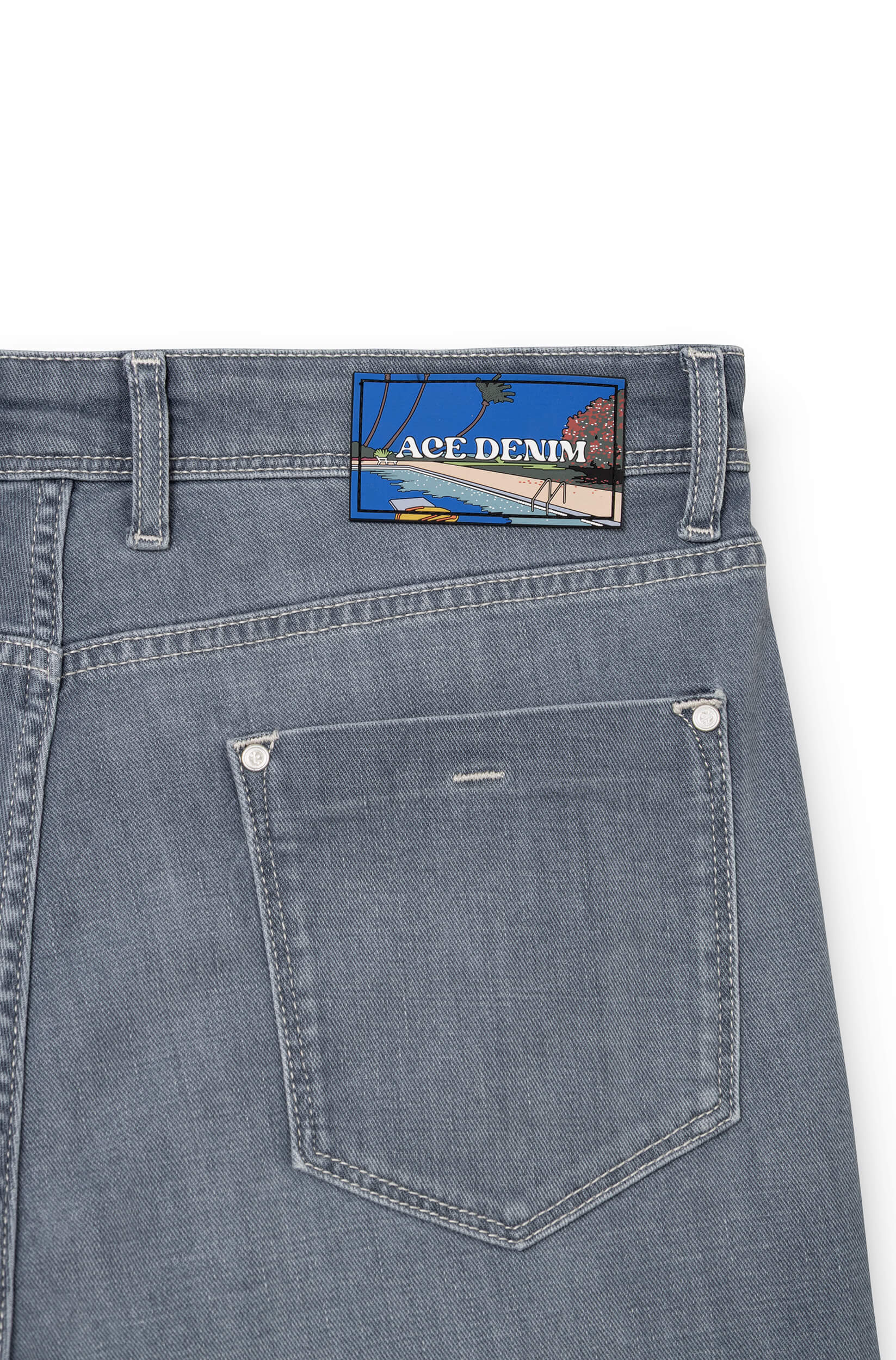 Detail of silicone signature patch on back waistband of light grey AD 33 — Ace Denim Paris