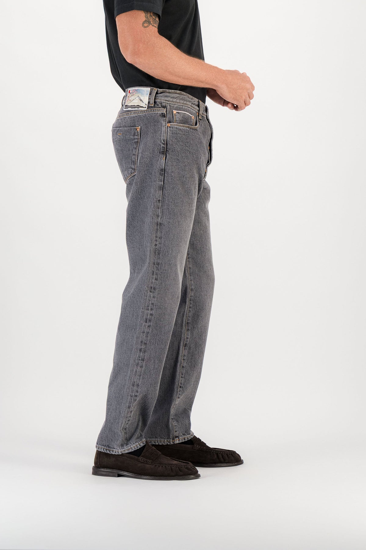 Grey selvedge straight jeans side view with cuff, signature embroidered patch visible on waistband — AD 53 Selvedge Ace Denim Paris