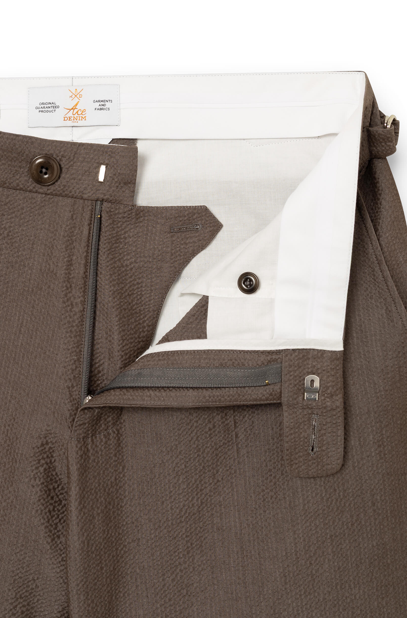 Detail of the zipper closure, button, and white inner lining — AD 52 Ace Denim Paris