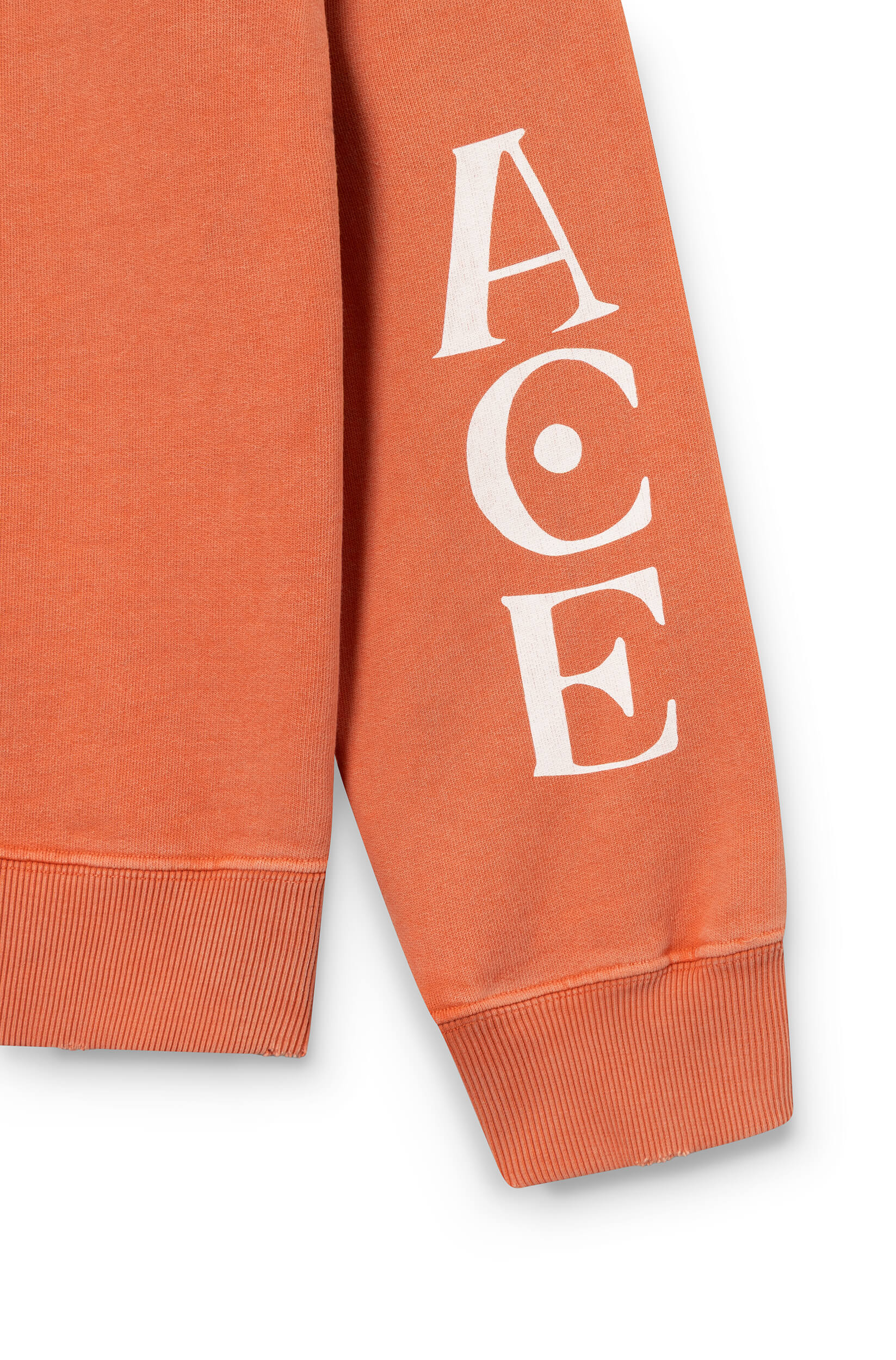 Close-up of the sleeve of the sweatshirt in orange cotton, hand-dyed and printed with a tiger by ace Paris