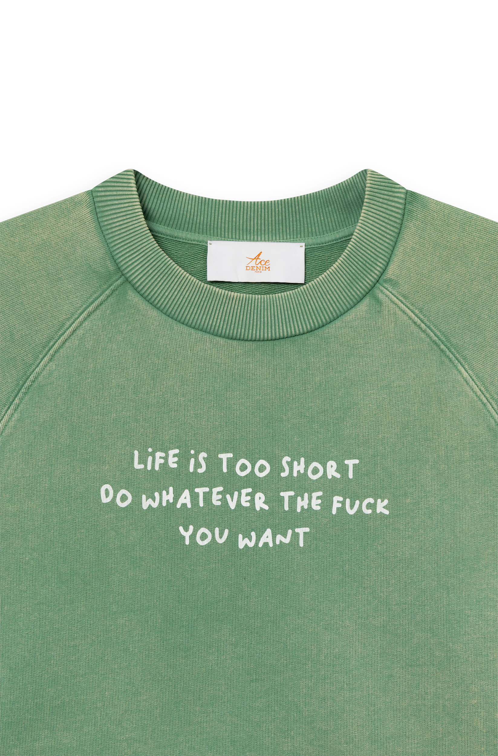Close-up of the green cotton sweatshirt dyed by hand with the phrase "life is too short, do whatever the f*** you want"