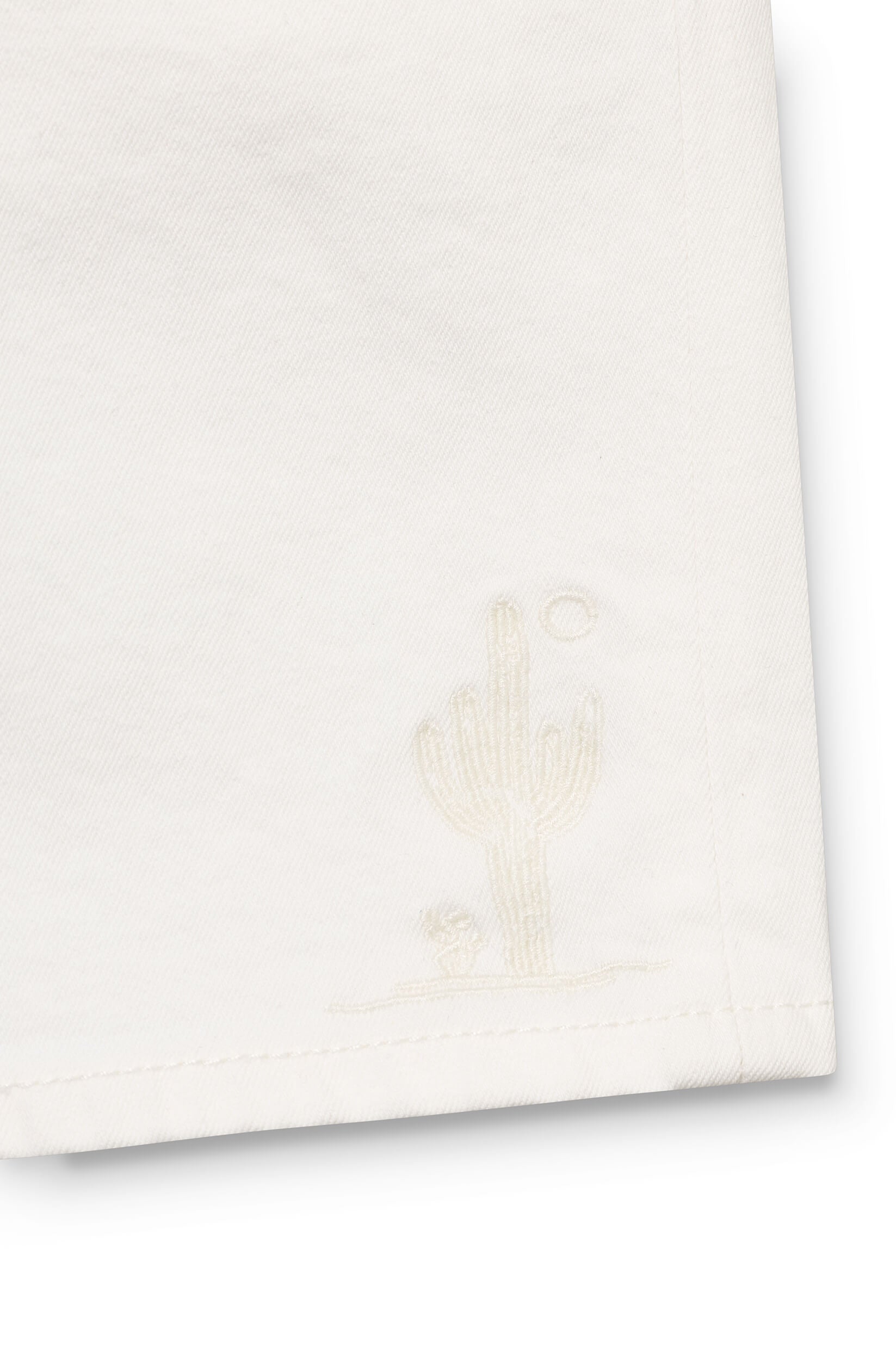 Close-up on the cactus pattern of the white shorts