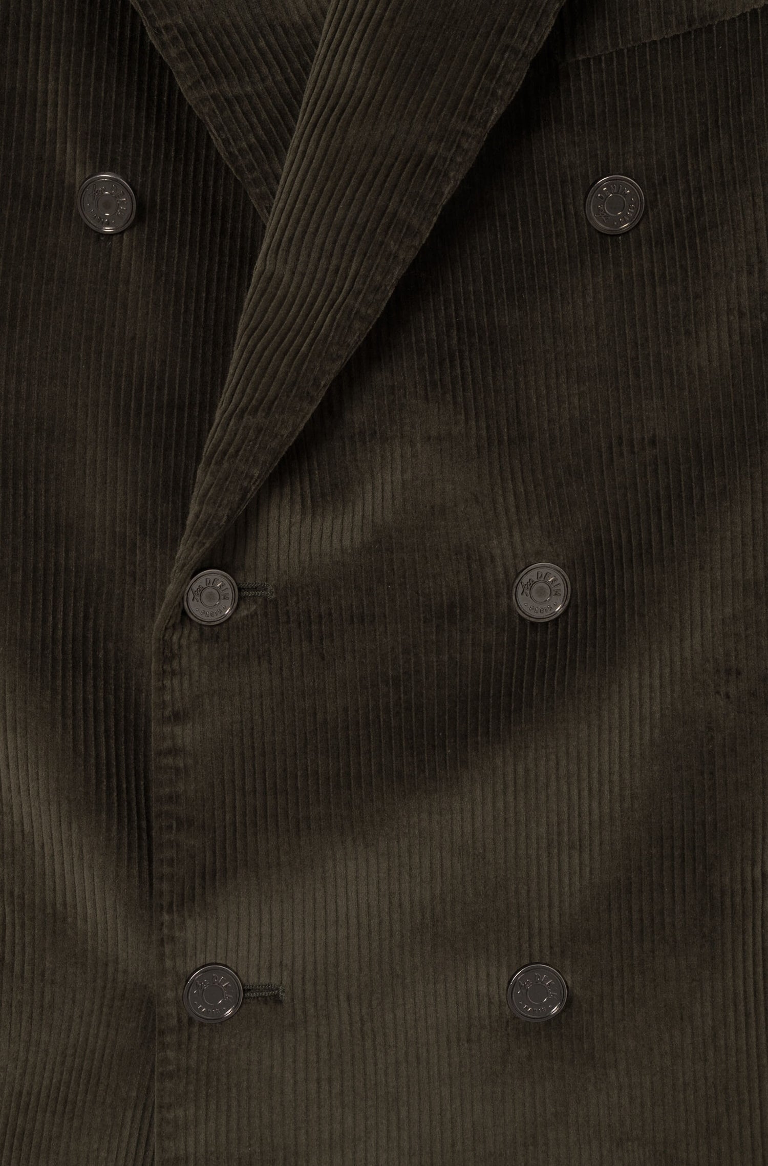 Detail of the metal buttons on the crossed jacket in khaki velvet