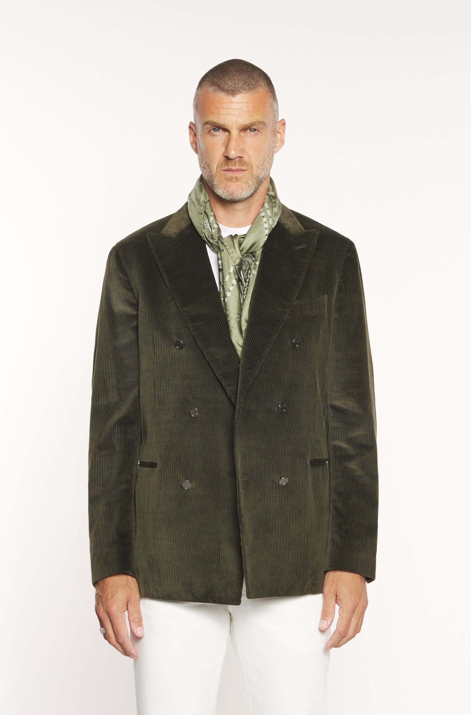Mannequin wearing the double-breasted jacket in khaki velvet with white trousers