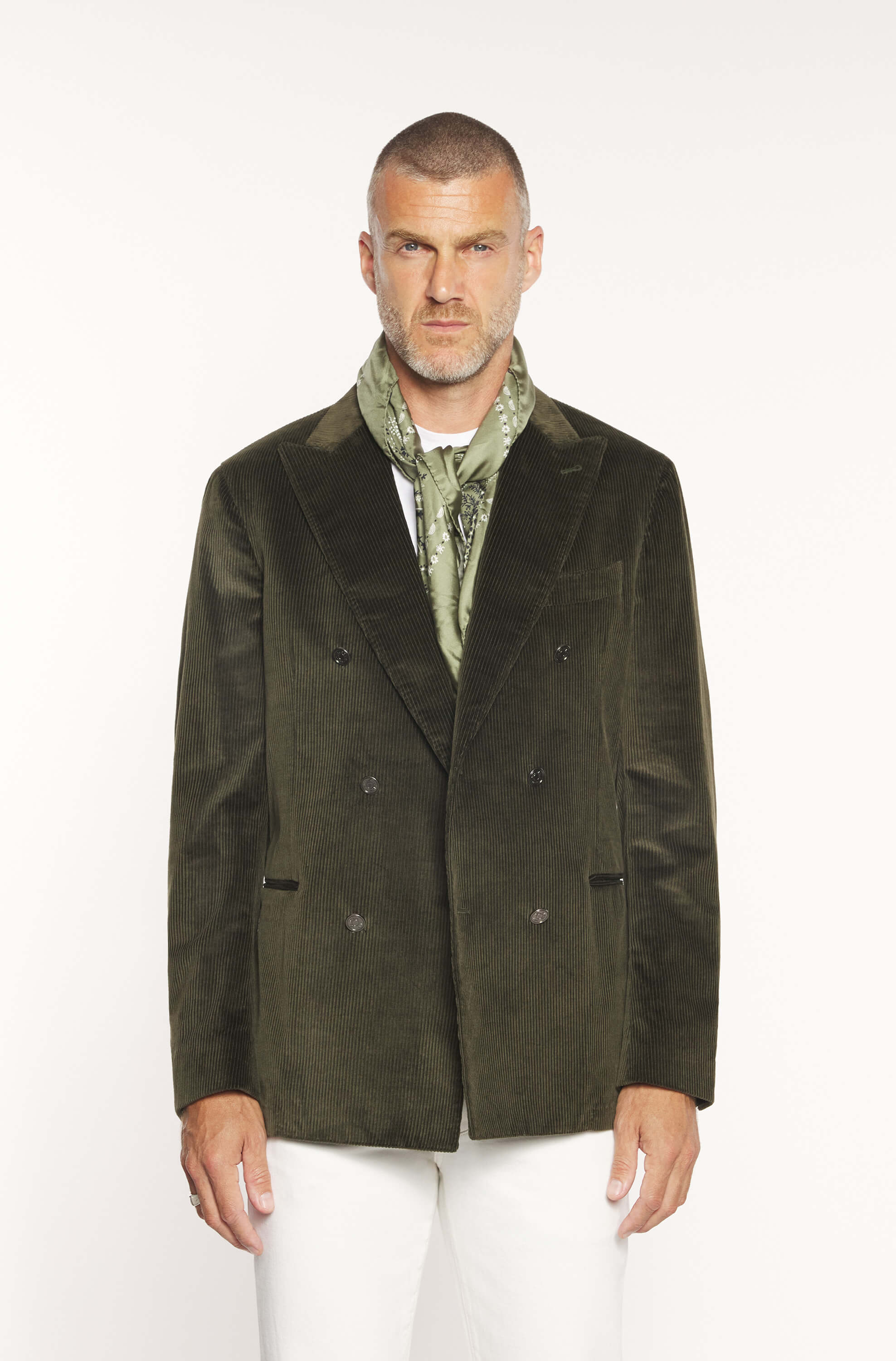 Mannequin wearing the double-breasted jacket in khaki velvet with white trousers