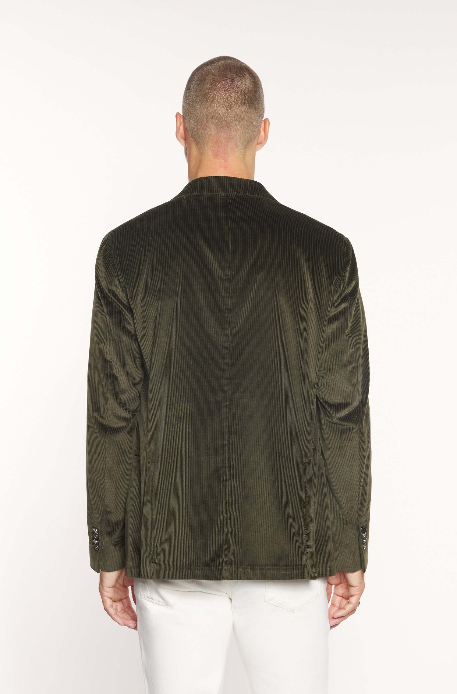 Rear view of the model wearing the crossed jacket in khaki velvet