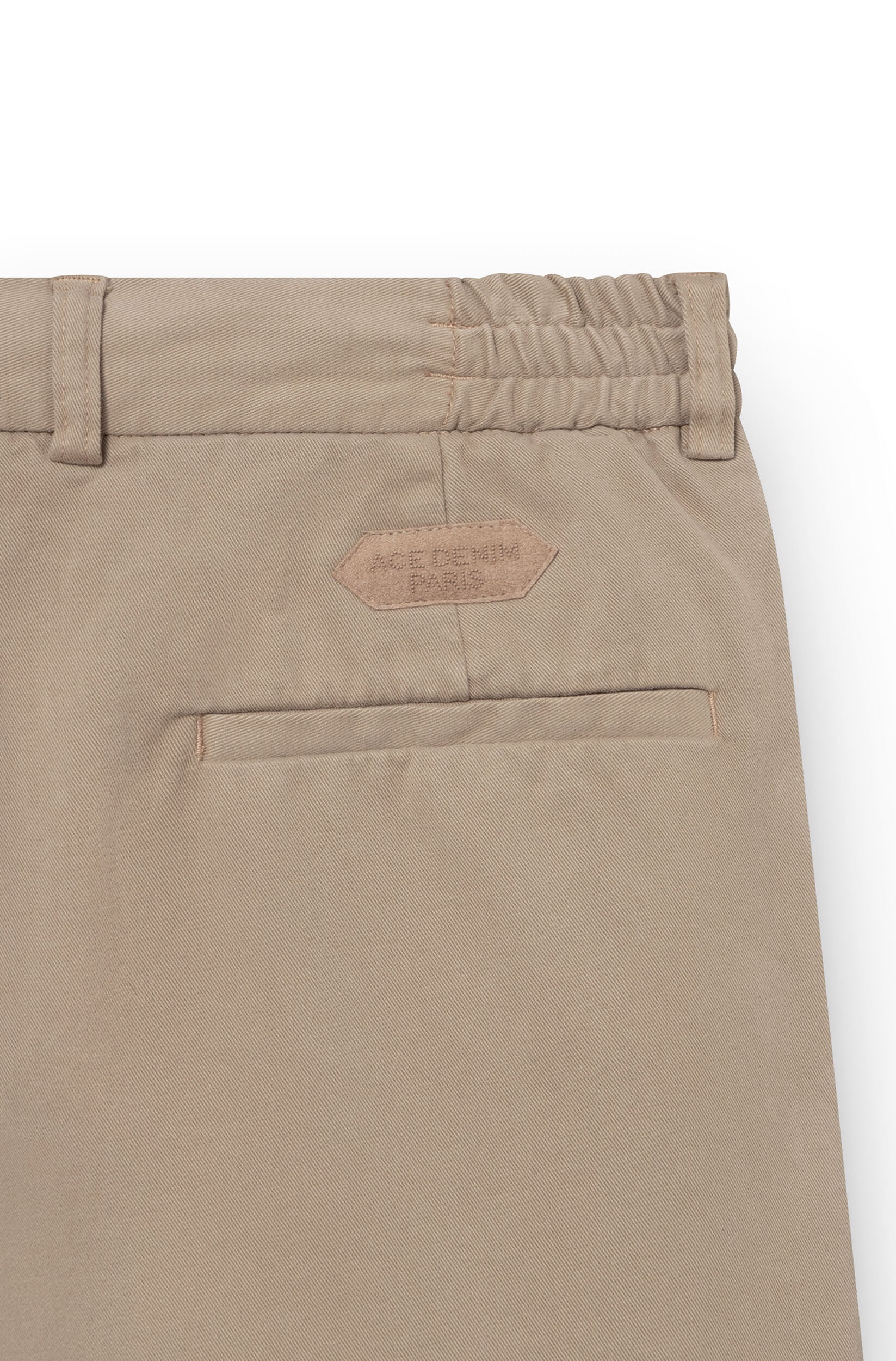 Embroidered patch on the back of the beige chino