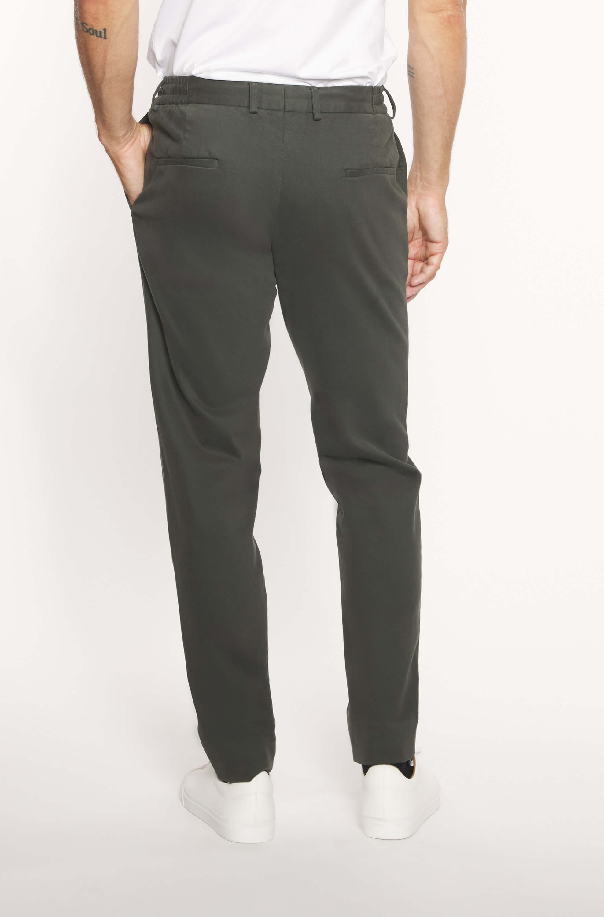 Back of the model wearing the slim khaki cashmere chinos for men