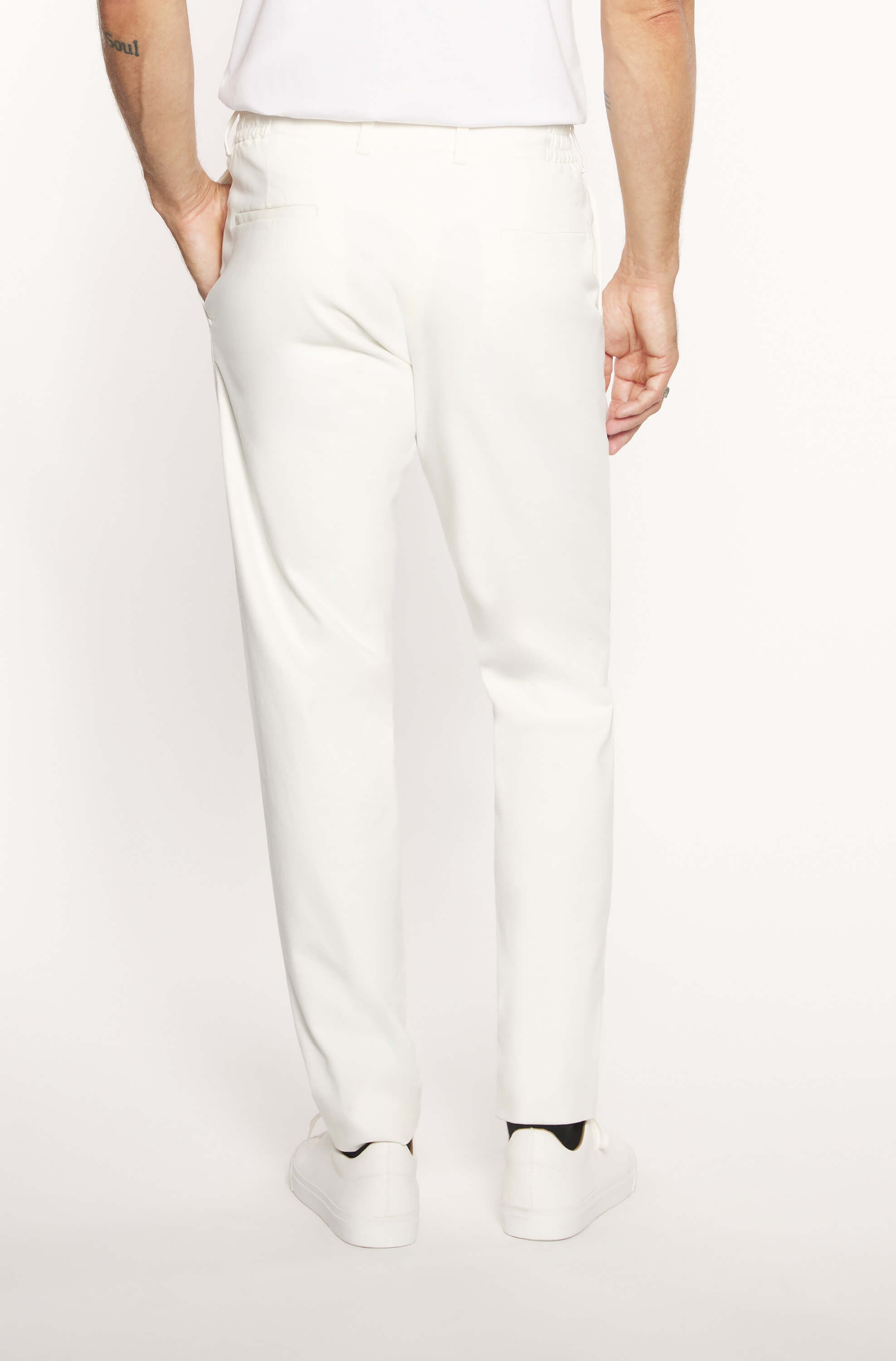 Back of the model wearing the slim cream white cashmere chinos for men