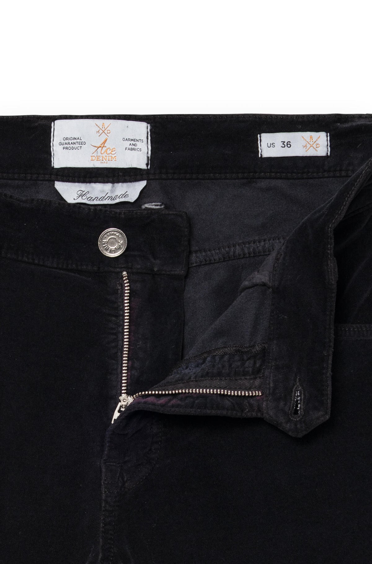 Close-up on the detail of the fly and the Handmade label