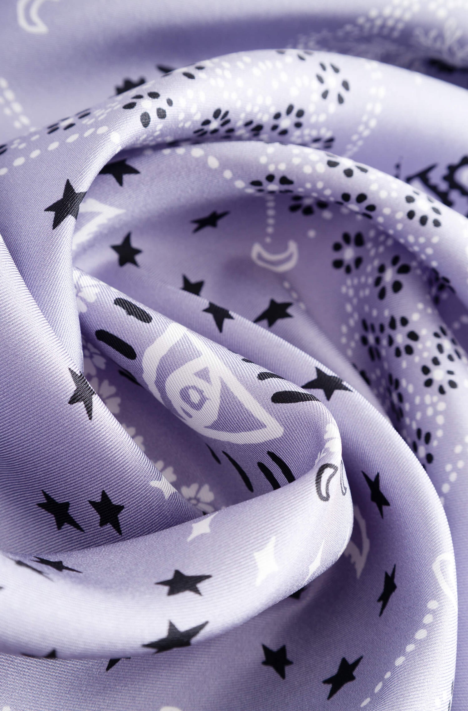 Detail with texture of the lilac silk scarf with bandana pattern