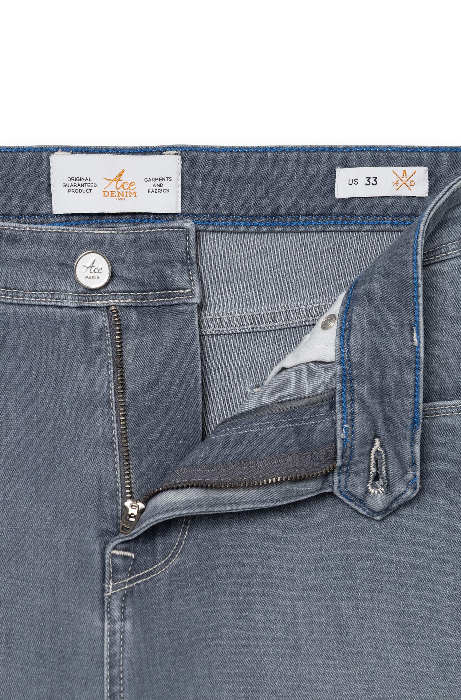 Detail of zip fly and engraved Ace Paris lacquered button with blue stitching — AD 33 Ace Denim Paris
