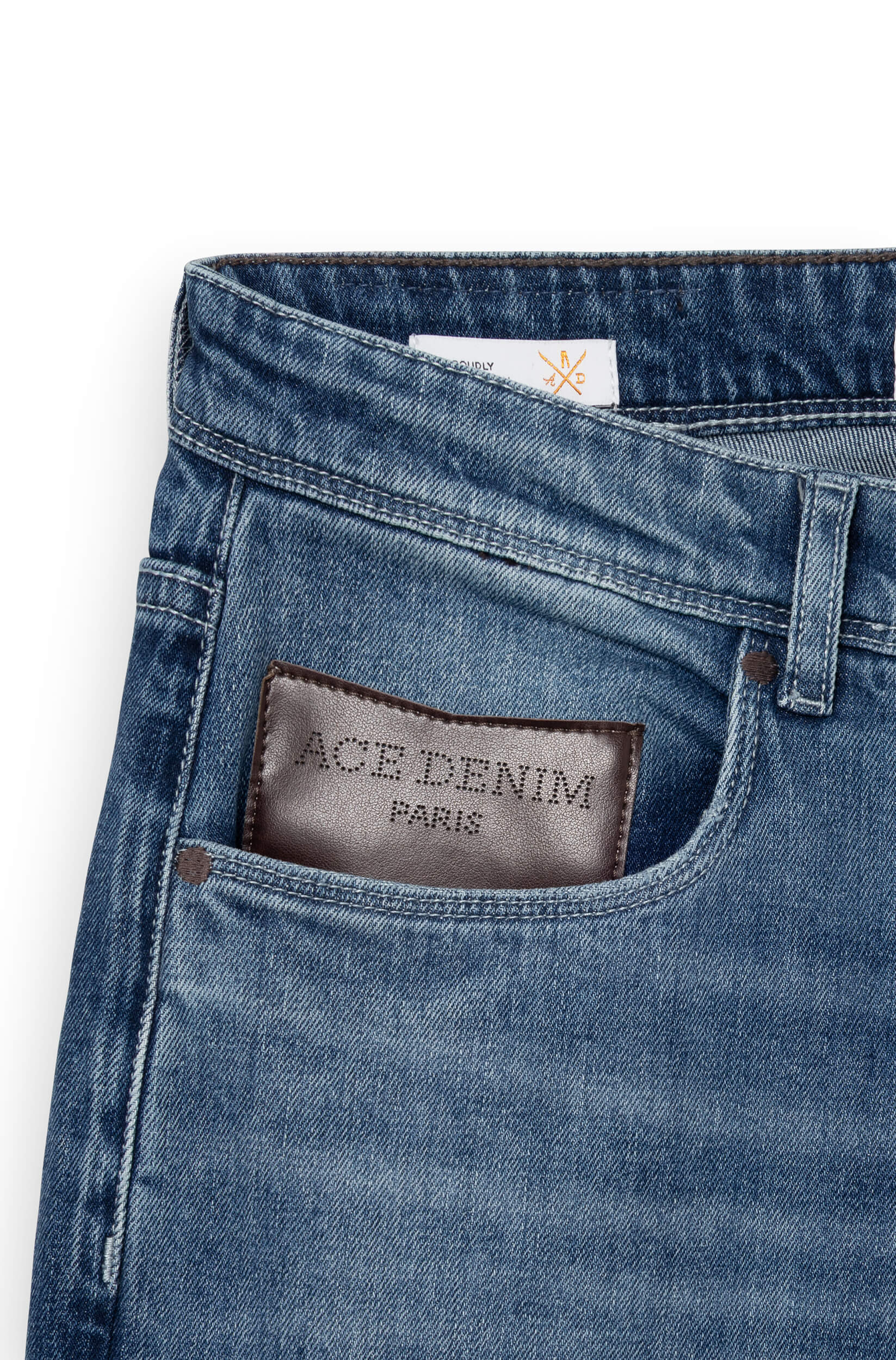 Detail of the brown leather patch on the front of the blue jeans AD03