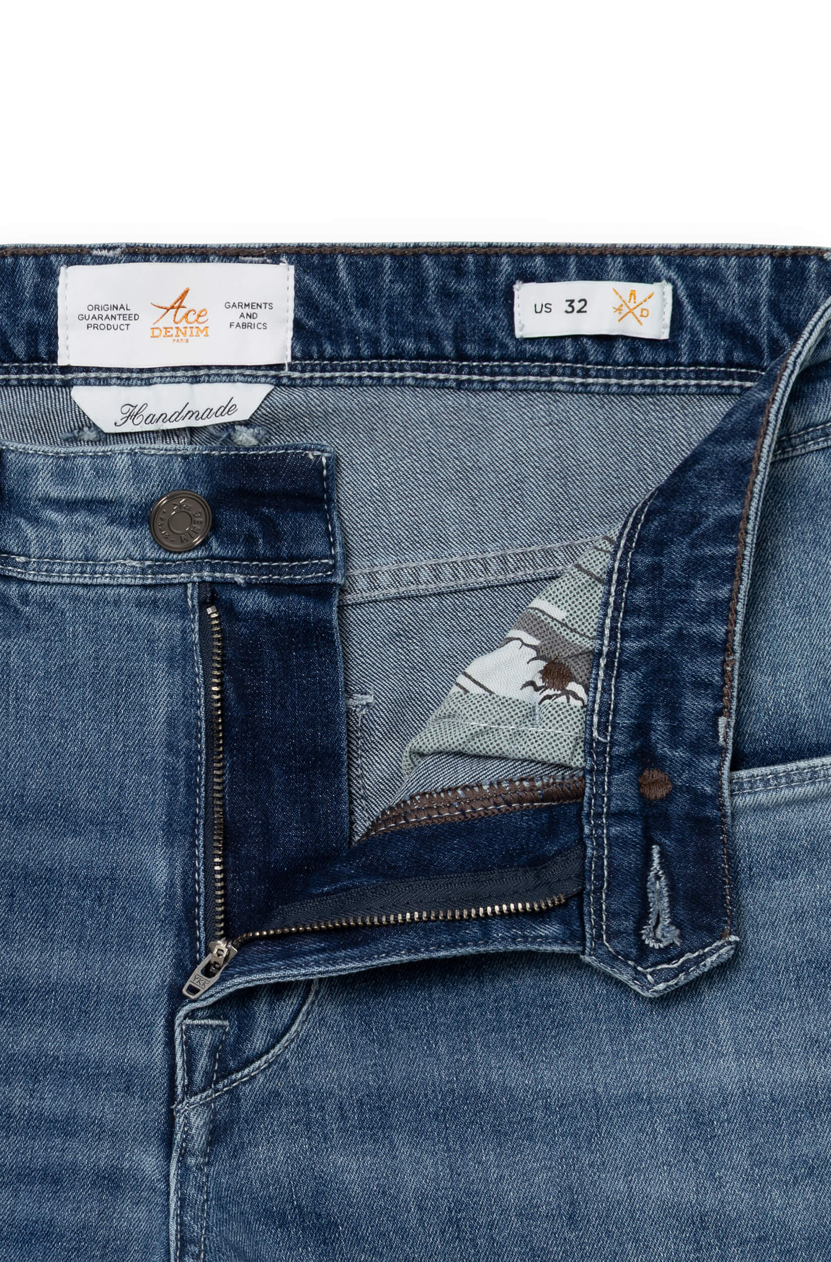 Detail of the front of the blue jeans with metal button and fly