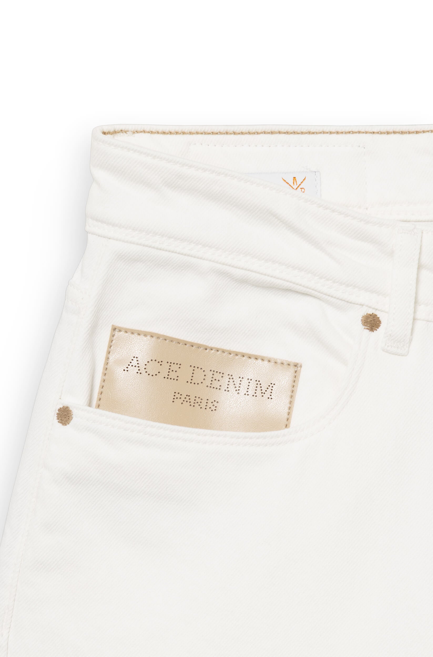 Detail of the beige leather patch engraved with Ace Denim Paris on the front of the jeans