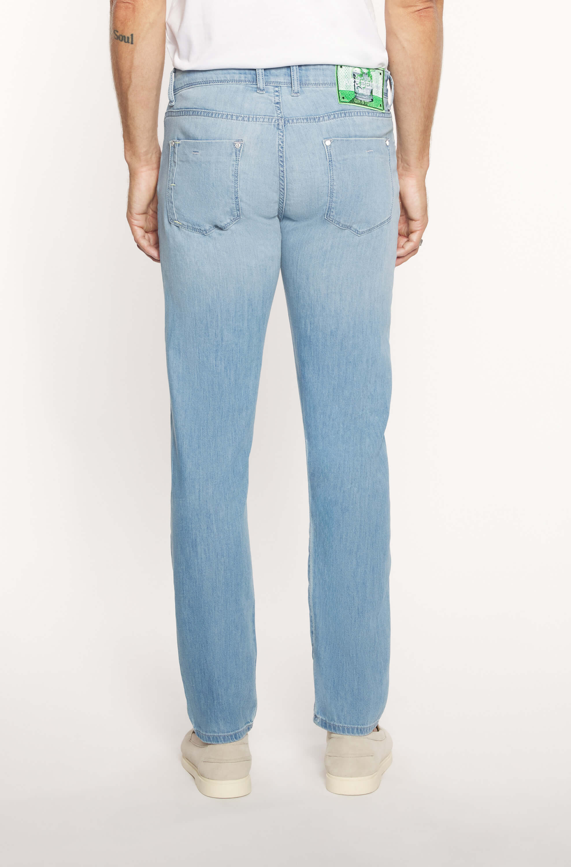 Back of the model wearing the slim jeans in faded blue cotton and linen for men
