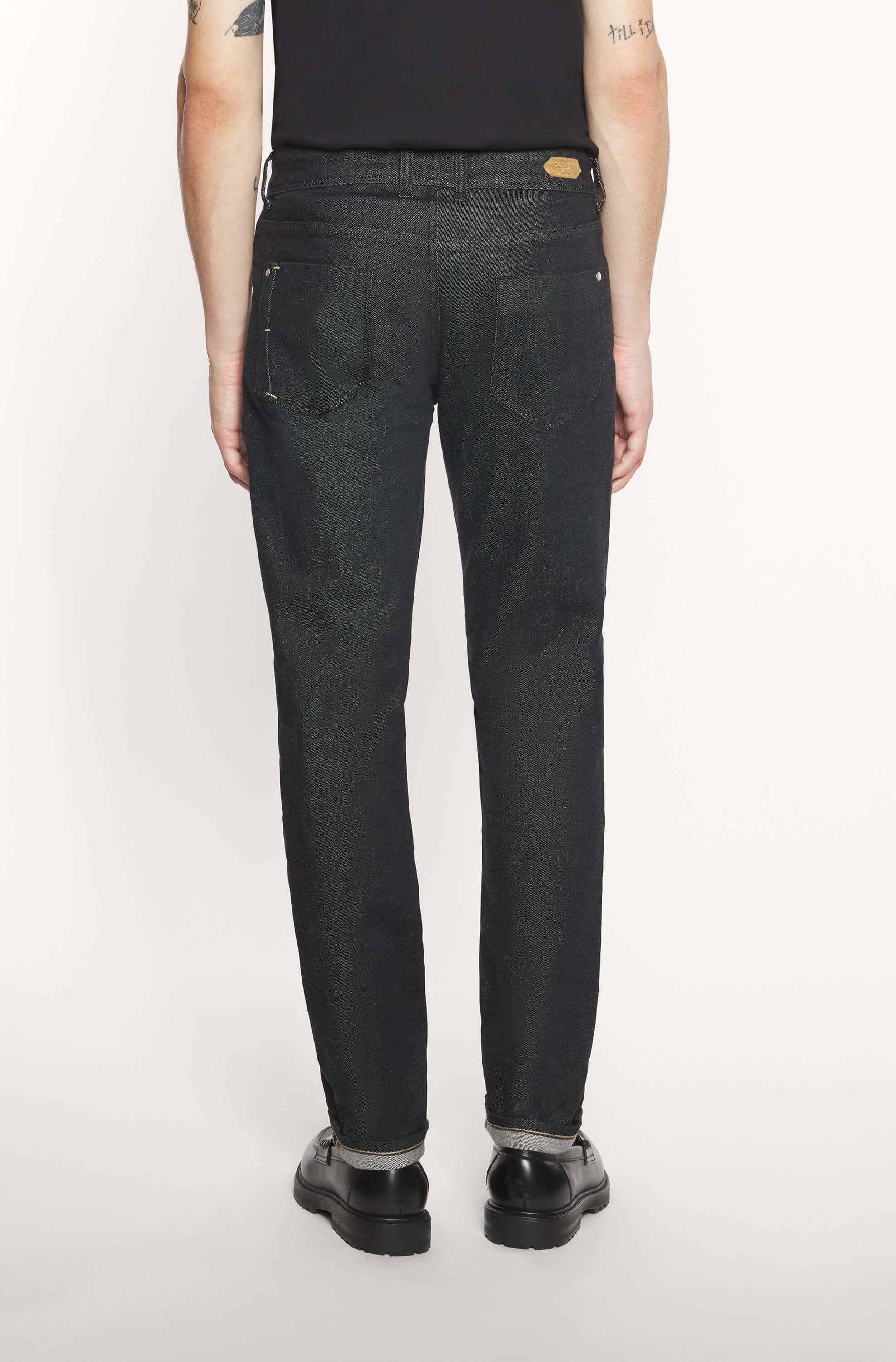 Rear view of the model wearing the black cashmere jeans