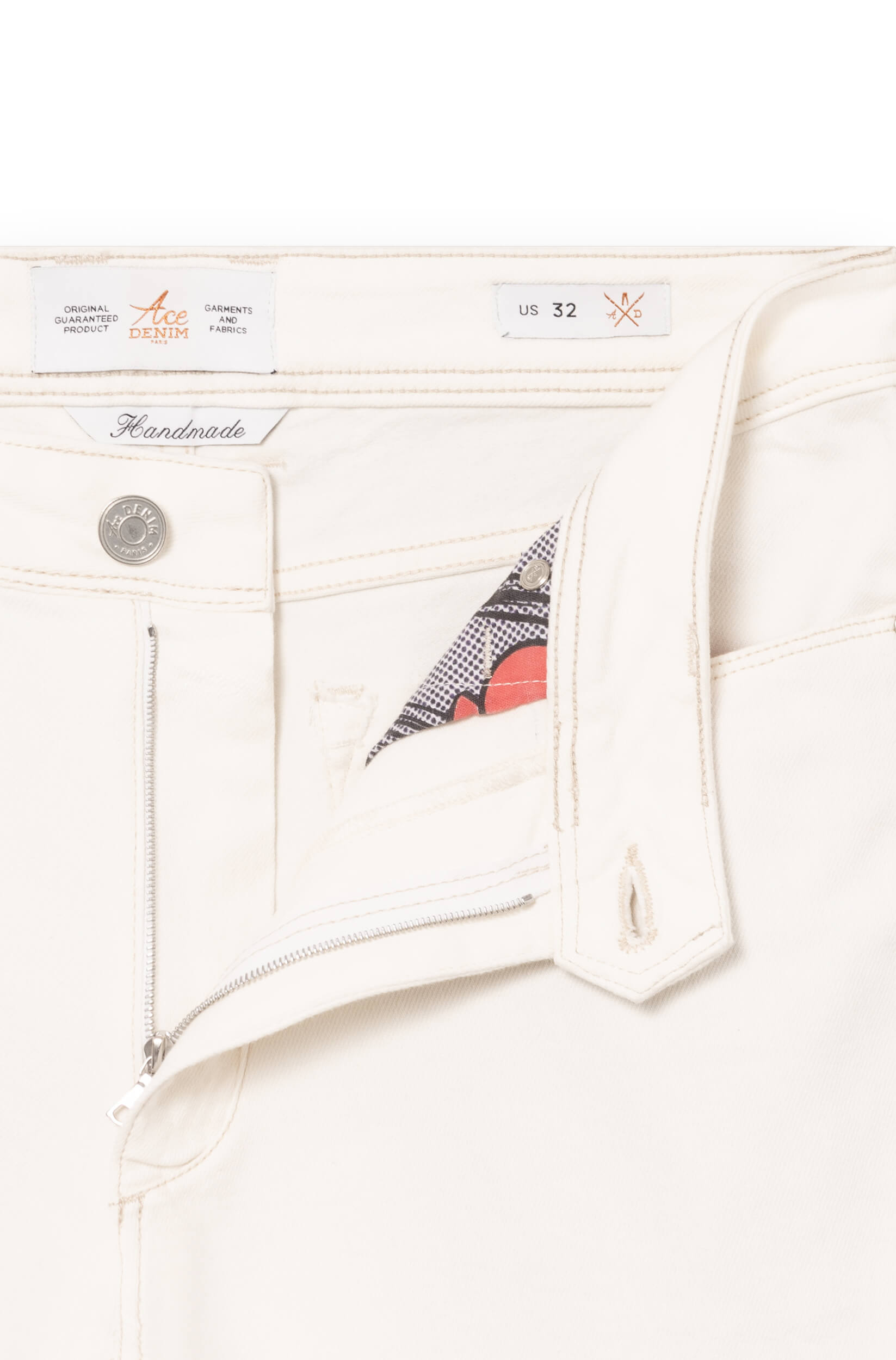 Detail of the fly and the metal button of the white cashmere jeans