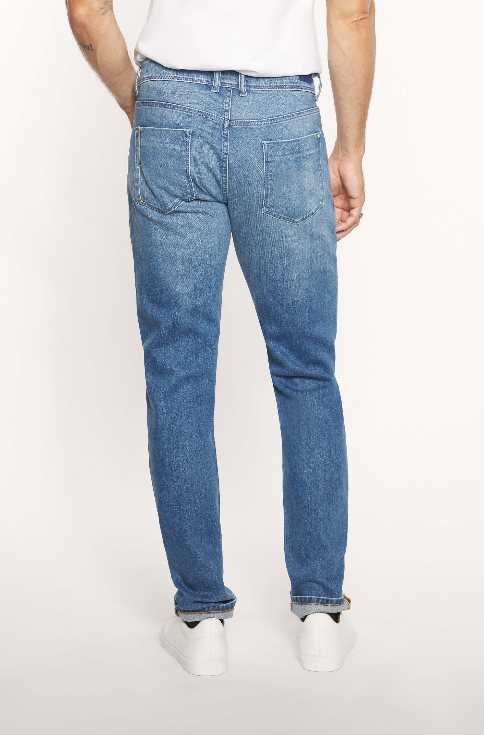 Rear view of the model wearing the light blue cashmere jeans