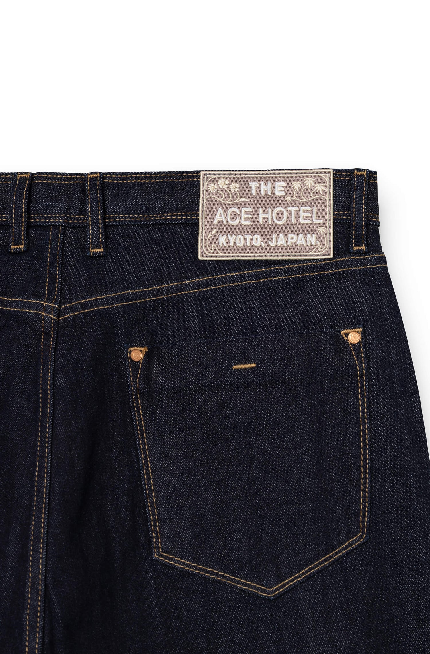 Detail of embroidered signature patch on back waistband of raw AD 53 Selvedge — Ace Denim Paris