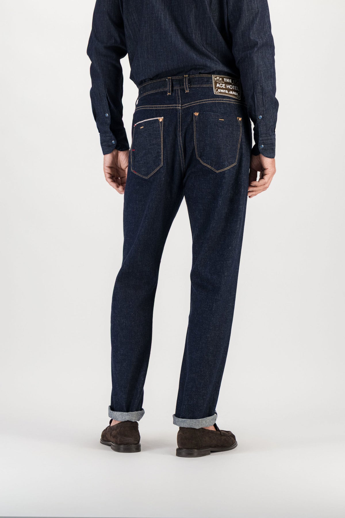 Back view raw indigo selvedge straight jeans worn, back pockets and signature embroidered patch — AD 53 Selvedge Ace Denim Paris