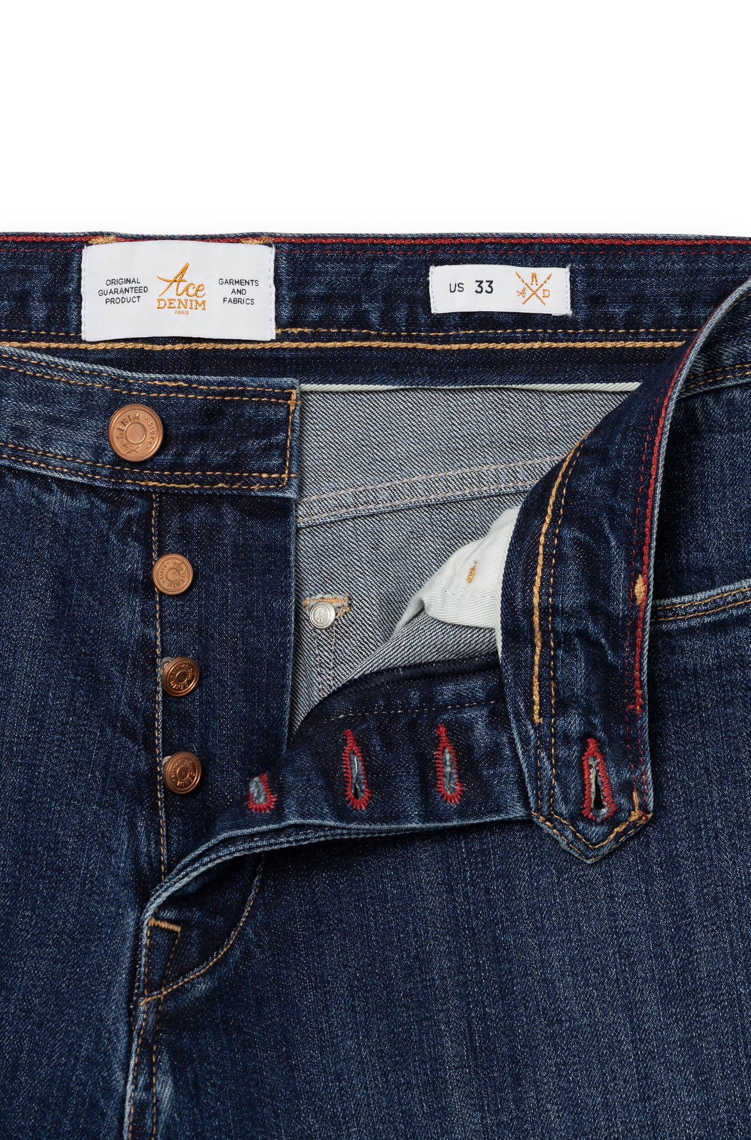 Detail of engraved copper button fly with red and gold interior stitching — AD 53 Selvedge Ace Denim Paris