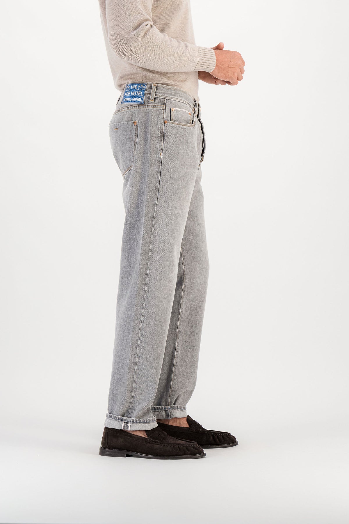 Light grey selvedge straight jeans side view with cuff, Ace Hotel Kyoto embroidered patch visible on waistband — AD 53 Selvedge Ace Denim Paris