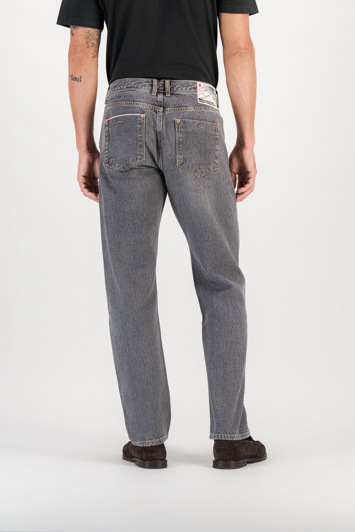 Back view grey selvedge straight jeans worn, back pockets and signature embroidered patch — AD 53 Selvedge Ace Denim Paris