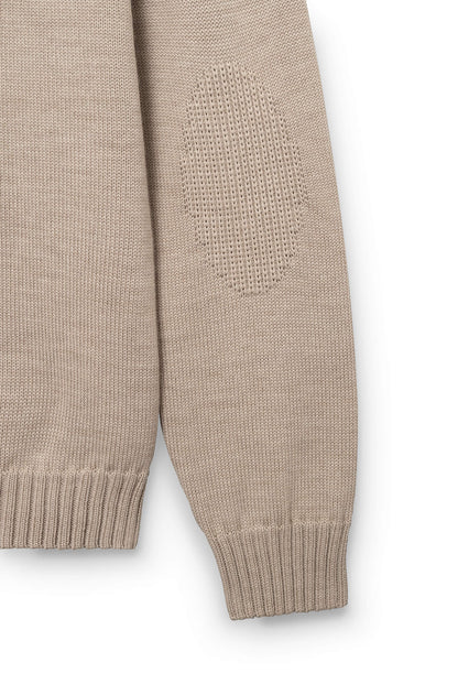 Detail of the sleeve of the beige pullover in merino wool