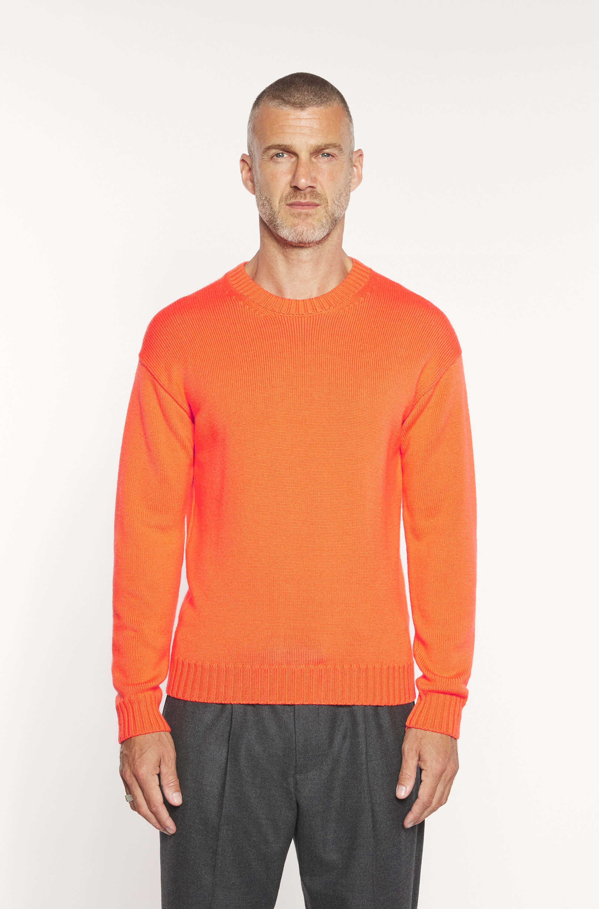 Mannequin wearing the orange round-neck sweater