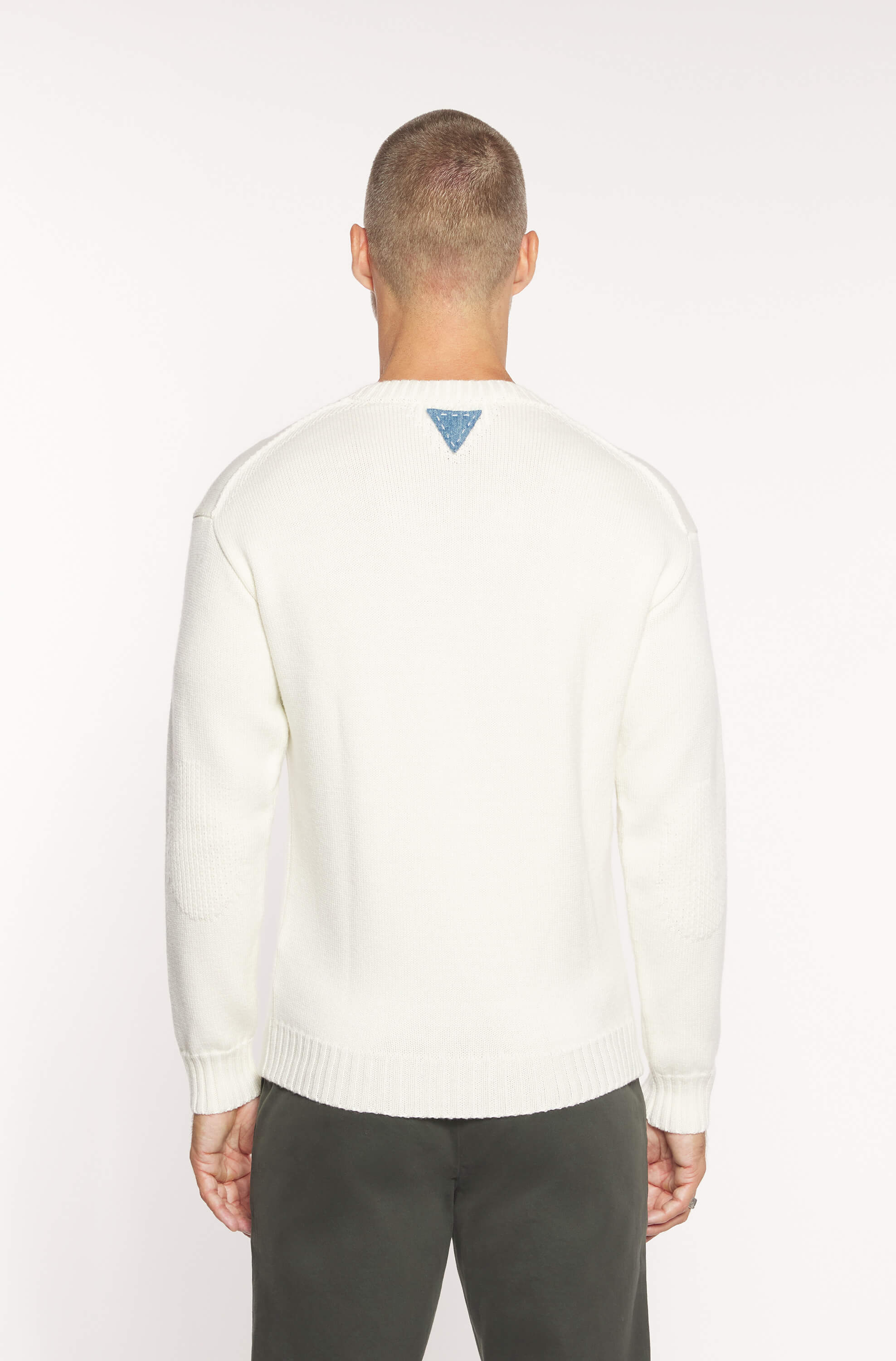 Rear view of the model wearing the off white sweater