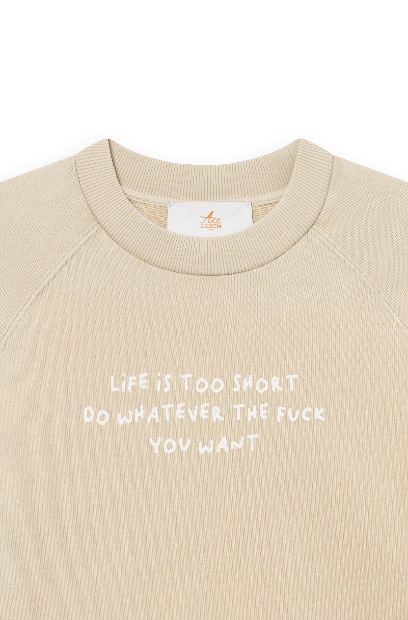 Close-up of the beige cotton sweatshirt dyed by hand with the phrase "life is too short, do whatever the f*** you want"